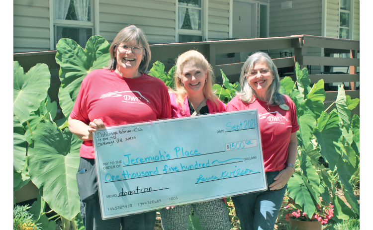 Dahlonega Woman’s Club President Laura Wilson (left) and Co-President Ali Murphy (right) present a check for $1,500 to Jeremiah’s Place Executive Director Della Lago. “Our number one goal is to raise money to support Lumpkin County residents,” Murphy said.