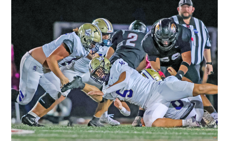 Gannon Melanson and the Lumpkin defense battle to make a stop.