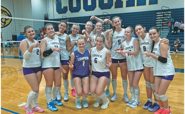 The Lumpkin volleyball team celebrates their big win over Crisp County in the first round of the State Playoffs.