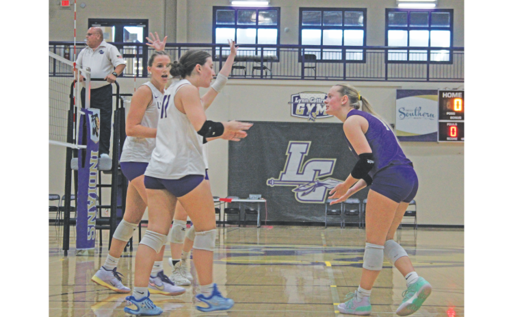 Trinity Henson (right), Hadley Glenn (center) and Emmie Kate Reese celebrate a score at a previous Lumpkin game.