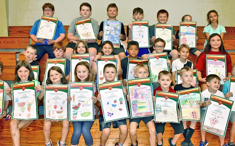 Park & Rec’s Day Camp participants took part in a poster contest for Community Helping Place Free Medical and Dental Clinics annual Tomato Sandwich Supper. Winners (first, second and third place) will be revealed Thursday, July 18, at Dahlonega Baptist Church during the event. Pictured are (first row, from left) Jacob Giles, Charlotte Gass, Madeline Gass, Jersey Ward, Colby Henderson, Micah Ellis, Christian Cotour, Landen Popham, Harlen Wager and Joey Moses; (second row, from left) Ethan Starley, Talon Ston