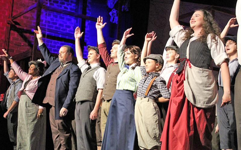 The cast of Newsies at The Holly takes a bow following its final rehearsal on Thursday, July 25. The show is filled with high energy dances and songs and keeps the audience engaged throughout, often taking the action off the stage and into the crowd. The musical is scheduled to run the next two weekends (August 2-4 and 9-11).
