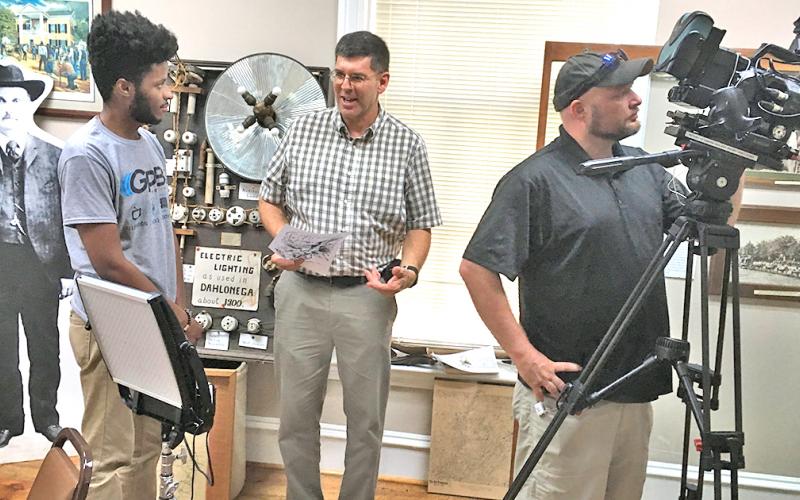 Associate producer Michael Harris (left) talks with Lumpkin County Historical Society president Chris Worick as videographer Wesley Nichols films segments for an upcoming episode of the GPB show Hometown Georgia to air on Oct. 31.