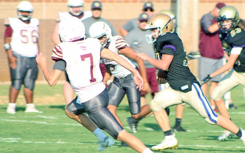 Running back Will Wood runs by two Dawson defenders on his way to his second touchdown of the day in the Indians’ 22-14 victory.