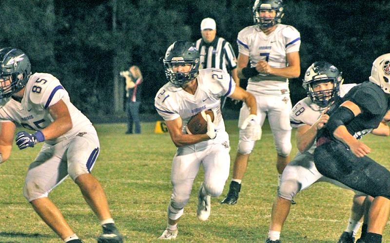 LCHS running back Tanner Barber utilizes some blocking to pick up some hard fought for yards in the Indians’ 31-0 loss to Jackson County.