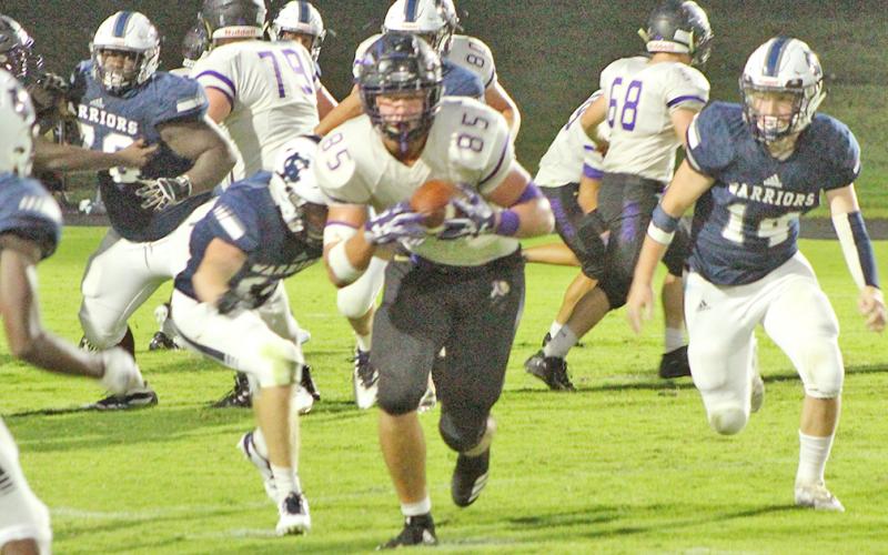 LCHS tight end Aaron Hopkins picks up some yards after catching a pass from Indians quarterback Tucker Kirk in the third quarter of Lumpkin’s game against White County last week.