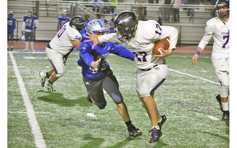 Running back Drew Allison returned from an injury with a vengeance Friday night, stiff arming a Fannin County defender on his way to a first down. (Photo by Jake Cantrell/The Nugget)
