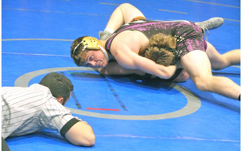 Lumpkin County wrestler Levi Seabolt pushes his opponents shoulders to the mat for a win by pin.