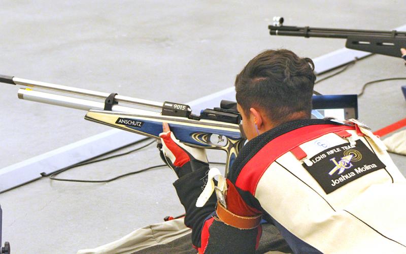 LCHS sophomore shooter Joshua Molina takes aim during the prone portion of competition. Molina shot perfect scores in prone and kneeling to help the Indians defeat North Forsyth last week, improving the team’s overall record to 5-1.