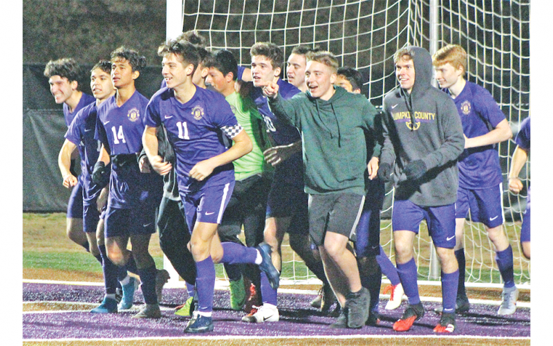 The Lumpkin varsity boys soccer team celebrates after defeating Murray County in penalty kicks to earn the team’s first win of the 2020 season.