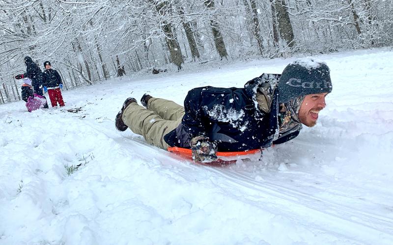 Caleb Sorrells takes full advantage of a surprise Saturday snowfall by taking a speedy sledding run.