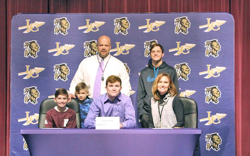 Tucker Kirk (front center) celebrates signing with Sewanee University with his family during a ceremony held at the LCHS auditorium recently. Pictured: (back row left to right) Kirk’s father and LCHS principal Billy Kirk, Kirk’s brothers Tanner Kirk, (front row left to right) Tate Kirk, Truett Kirk and his mother Jennifer Kirk.