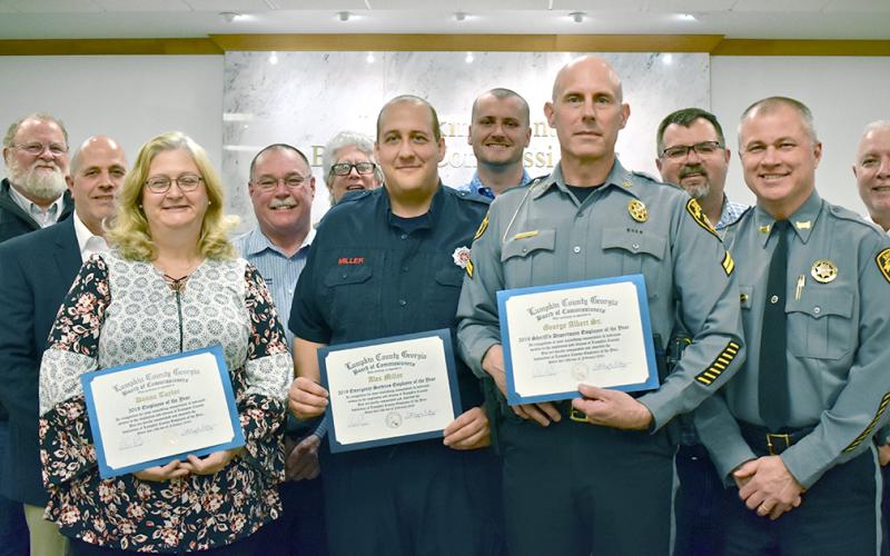 Donna Taylor from the Planning Department (front row, left to right), Fire/EMS’s Alex Miller and SRO Officer George Albert Sr. are Lumpkin County’s 2020 Employees of the Year. The trio were honored at last month’s BOC meeting. Standing with those being honored are (back row, from left) Public Works Director Larry Reiter; Commissioner Jeff Moran; EMS Director David Wimpy; Commissioners David Miller, Rhett Stringer, Chris Dockery; Sheriff Stacy Jarrard; and Commissioner Bobby Mayfield.