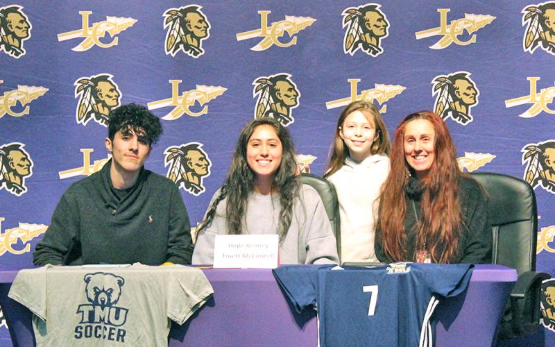 Lady Indians all-time leading goal scorer Hope Kenney (center) celebrates signing with Truett McConnell University at a signing ceremony held at the LCHS auditorium. Pictured (left to right): Kenney’s twin brother Jack Kenney, Kenney’s sister Raini Chandler and Kenney’s mother Rachel Kenney.