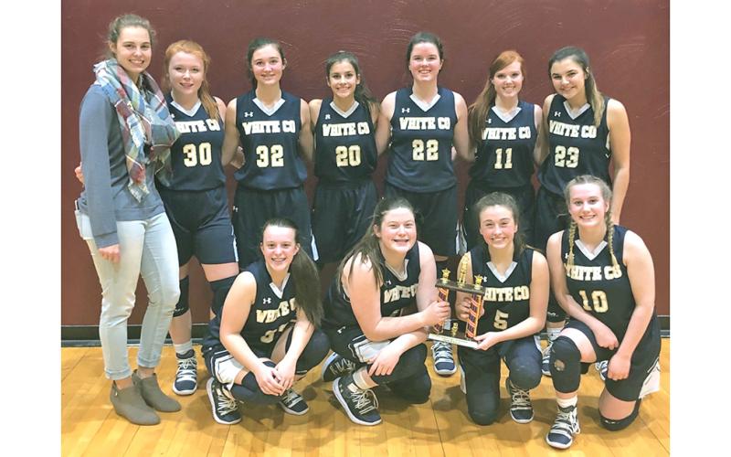 Former Lumpkin County basketball player Dakota Sullens poses with her JV team in her first season as White County JV head girls basketball coach. The former Lumpkin standout has coached at White County for the past two seasons.