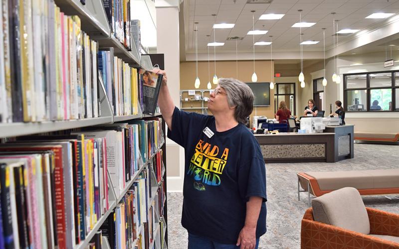 Lumpkin County’s new and improved library is ready, but still waiting for safety clearance, before staff members like Susie Schnebelen can officially open and welcome the public. (photo by Matt Aiken)