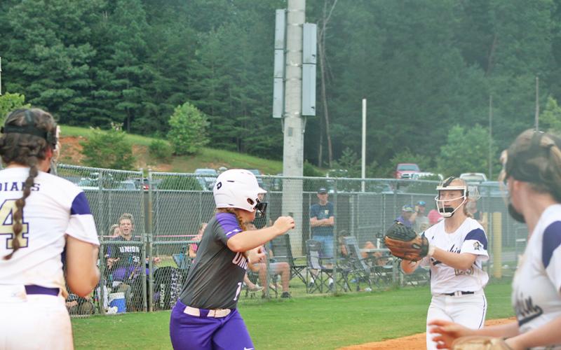 Lady Indians Kelsey Marshall and Kloee Graham run down a Union County player for an out.