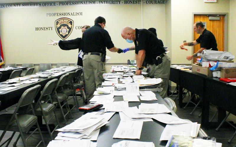 Members of the Lumpkin County Sheriff's Office investigations unit spent hours sorting through bags and bags of recovered mail, in order to return the postage to its intended recipients, after the mail was allegedly stolen.