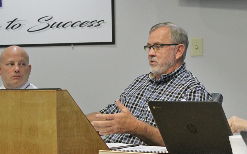 Superintendent Dr. Rob Brown (left) and board member Jim McClure speak at the Board of Education meeting on Monday.