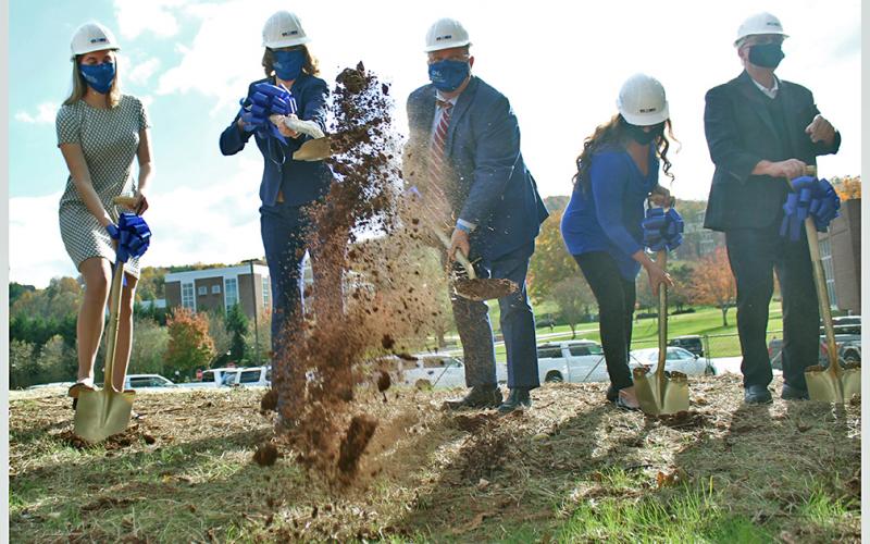 Betsy Wilcauskas (from left), Dr. Mary Gowan, Dr. Mac McConnell, Lynn and Mike Cottrell break ground at the future site of the Cottrell Center for Business, Technology and Innovation.