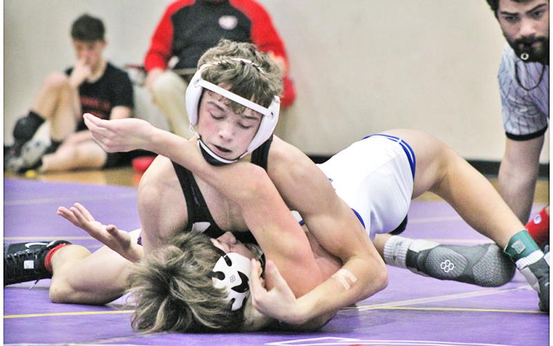 Jack Irwin, the lone returning state placer for Lumpkin, finishes off his opponent with a pin to claim third place in the 145 lb. weight class at the John Smith Invitational Wrestling Tournament held at LCHS on Friday and Saturday.