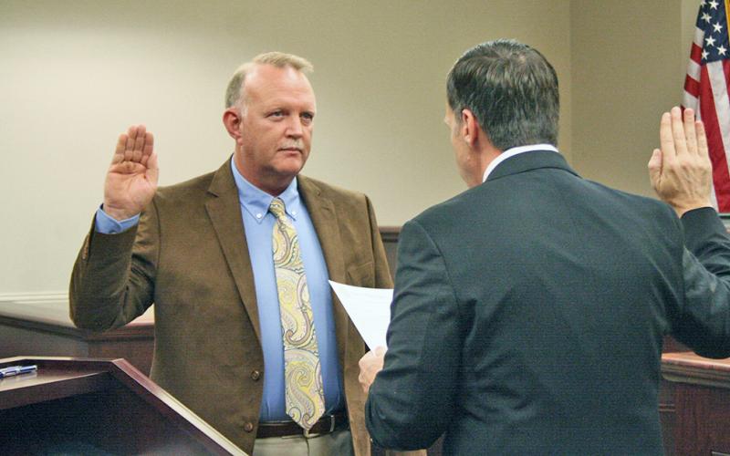 New Lumpkin County Magistrate Court associate judge Jim Sheppard is shown swearing in as the county coroner.