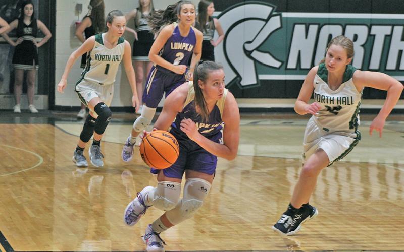 MaKenzie Caldwell dribbles down the court on the fast break after getting a steal during Tuesday’s game at North Hall. Caldwell led the team with three of the team’s 10 steals, which helped the team shut down the Trojans’ offense and keep their win streak alive.
