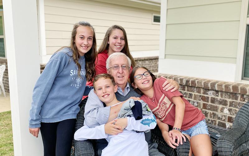 Fred Weil lived well. And he was cherished by his many grandchildren, standing from left, Claire Lacy and Haley Weil; front from left, AJ Weil and Charlotte Sessions.