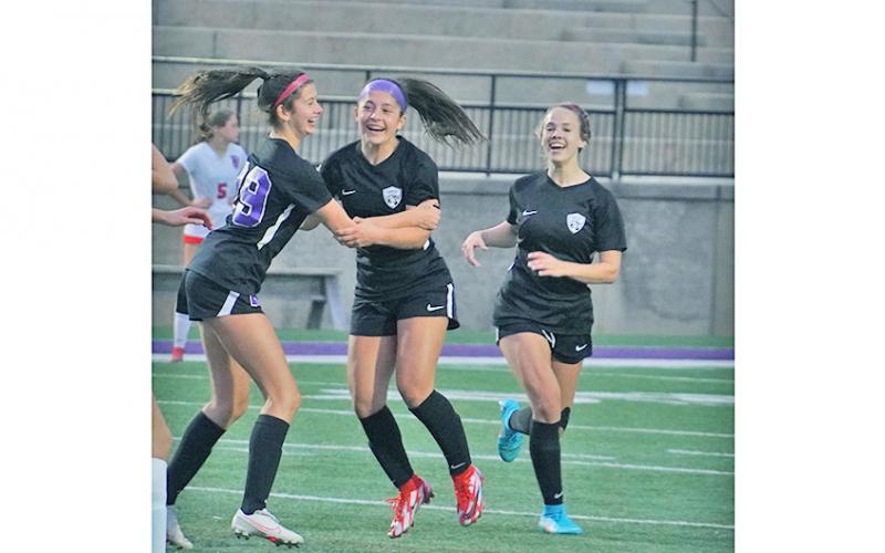 After scoring what turned out to be the game-winning goal in overtime, Andrea Limehouse (left) celebrates with her teammates (from left) Nicole Limehouse and Bri James.
