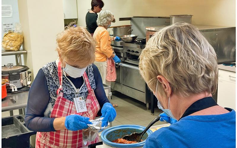 Volunteers at Dahlonega United Methodist Church prepare a hearty meal for curbside pick up last year for the Annual Spaghetti Supper to benefit Jeremiah’s Place.