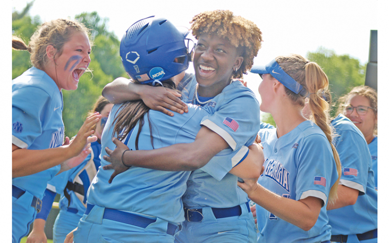 After being held in check for most of the day, the Nighthawks exploded, first on the field, then in celebration as Mariah Wicker (right) hugs teammate Madison Simmons after her teammate scored from first to give UNG its first lead of the day in extra innings of the season-determining game. Now the squad is headed to Denver for the NCAA Division II National Championship.
