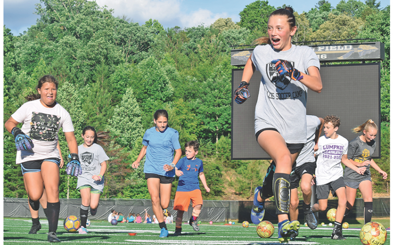 Campers scramble through the gauntlet as a high-intensity version of soccer-dodge-ball tests their agility at the community soccer camp at Lumpkin County High School last week.