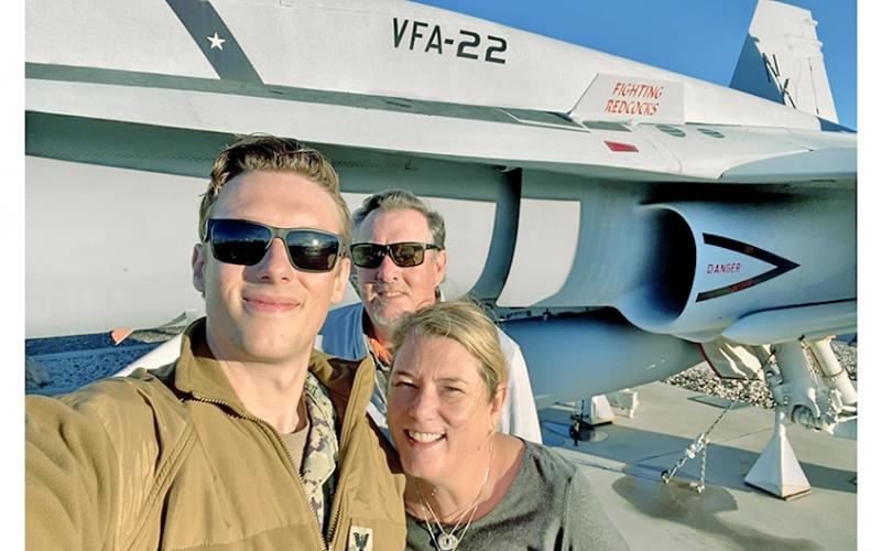 Petty Officer 1st Class Chandler Alexander feels the need, the need to lead in the TOPGUN training program. The Lumpkin County High School alum is pictured alongside his proud parents Steve and Casey Alexander.