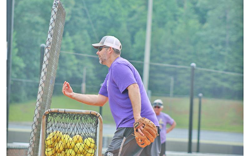 Head coach Joseph Jones delivers batting practice to his players during the final practice before the GHSA Dead Week.