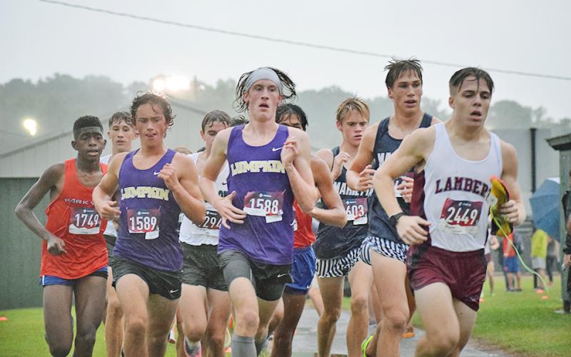 Lumpkin County High School runners, Wyatt Windham, left, and Ben Sherrill pushed through the sloppy conditions to finish with new personal records at the weekend meet in Pickens County.