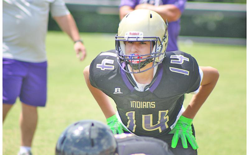 Middle school linebacker Mason Torres looks into the backfield with focus, anticipating the snap, during a Lumpkin County practice last week.