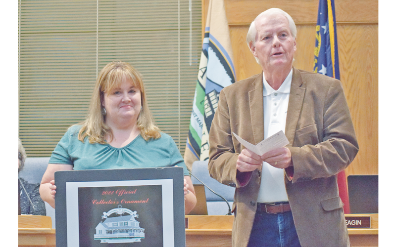 Community Helping Place Director Melissa Line stands alongside council member Ron Larson as the much anticipated CHP fundraising Christmas ornament was officially unveiled at last week's Dahlonega City Council meeting.