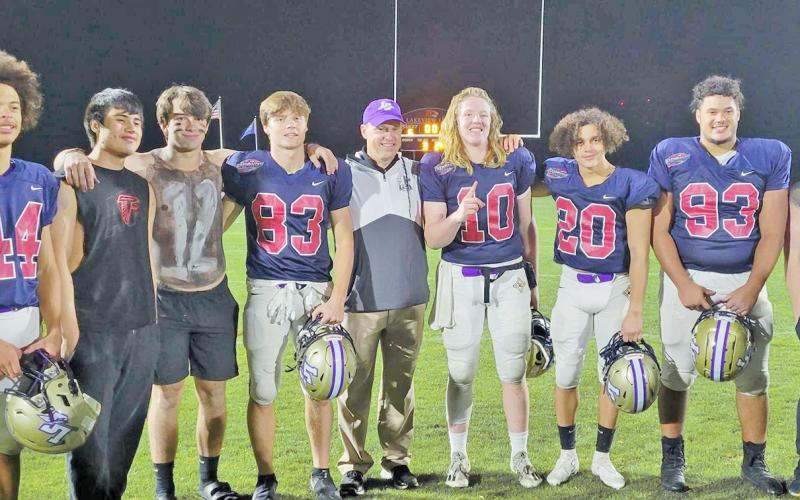 Players representing Lumpkin County in the FCA East vs. West All-Star Classic were (from left) Cam Stringer, Mason Sullens, Caleb Norrell, head coach Heath Webb, Cooper Scott, Tavion Lawrence and Jay Grizzle alongside members of the LCHS Crunk Crew.
