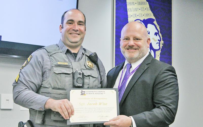 Sergeant Jacob Wise is presented with the 2022 Georgia RISE Award by Lumpkin County Schools Superintendent Dr. Rob Brown.