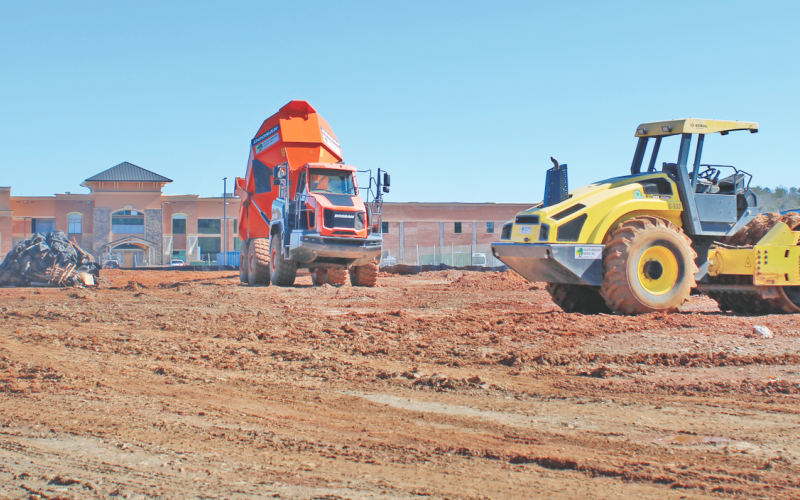 Construction vehicles mobilize in front of Cottrell Elementary, near the future site of the new recreation center.