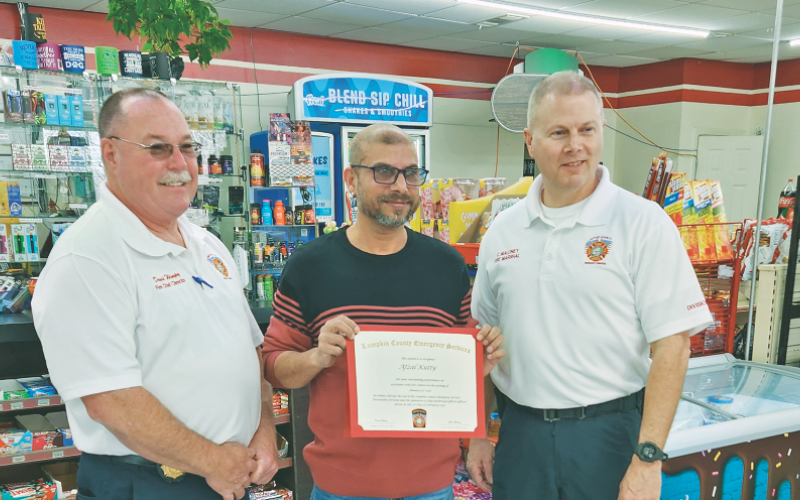 Afzal Kutty of the local “Disco” Marathon gas station was recently recognized by Lumpkin County Fire Chief David Wimpy (left) and Fire Marshal Chris Maloney. Kutty acted quickly on the night of January 15 to extinguish a blaze that occurred after a driver of a Jeep lost control and collided with the gas pump.