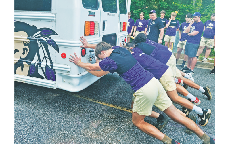 The LCHS football team competes in their first summer burn competition where they raced to push a bus over a long distance.