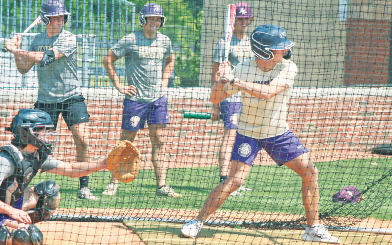 Lumpkin’s Colton Lee steps up to bat, while Kendal Lee sits steadily as the catcher, and Matthew Mitchell, Adian Rogers and Chase Smith look on.