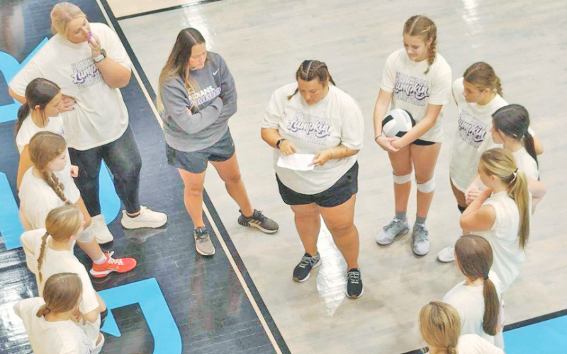 The Lumpkin volleyball team discusses their game plan ahead of the scrimmage game.