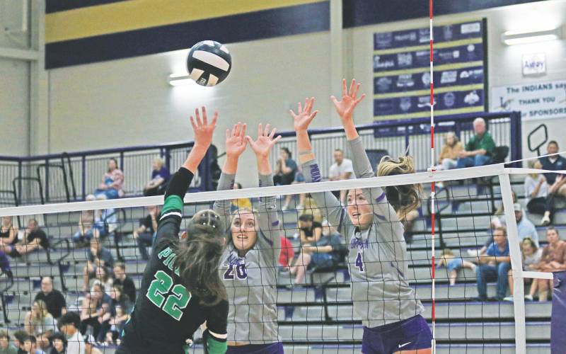 Morgan Powell, right, and Mary Richardson attempt to make a block at the net.