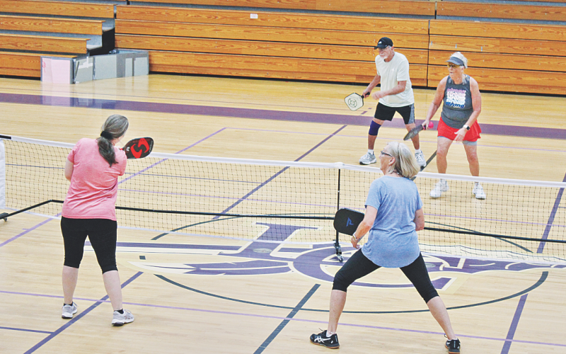 Pickleball players (foreground, from left) Tracie Grizzle and Sally Trapnell face off against the team of (background, from left) Dennis Weinman and Phyllis Gailey on an indoor court at Lumpkin County Parks & Rec.
