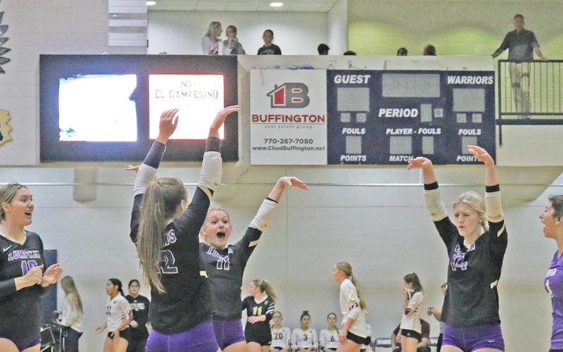 The Lumpkin Lady Indians celebrate scoring a point against Wesleyan.