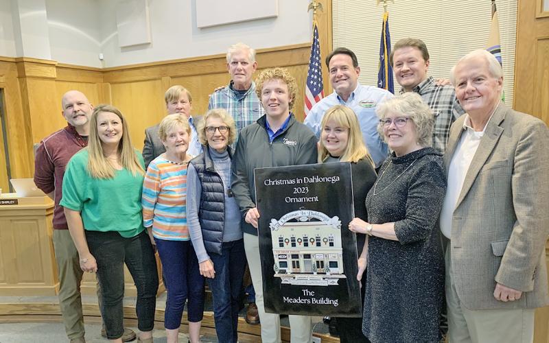 The much anticipated Community Helping Place fundraising ornament was unveiled at the Dahlonega City Council meeting earlier this month. This year's ornament features the golden facade of the Meaders Building. (Photo by Matt Aiken)