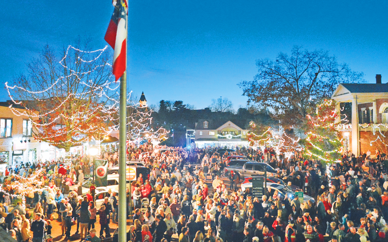 Thousands of visitors and locals filled the downtown area for the lighting of the square on Friday.  Local musicians Radford Windham and Chuck Bell filled the night air with holiday music before and after.  On hand to perform the ceremonial lighting of the square were UNG President Michael Shannon, Dahlonega Mayor JoAnne Taylor and Lumpkin County Chairman Chris Dockery. (Photo by John Bynum)