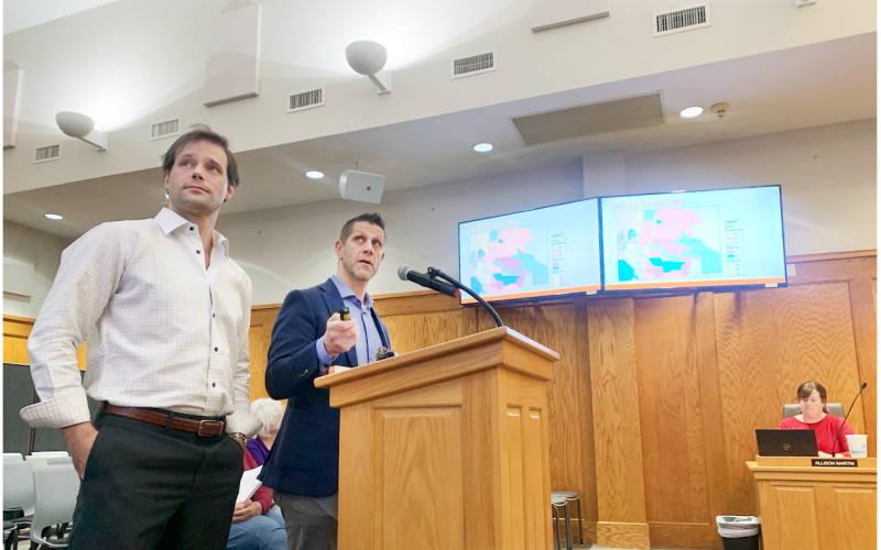 During the recent City Council public hearing, consultant Logan Moye, left, and zoning attorney Ethan Underwood discuss the proposal that could bring a 228-unit townhome development to a 62.77 acre plot just off of Pinetree Way in downtown Dahlonega.